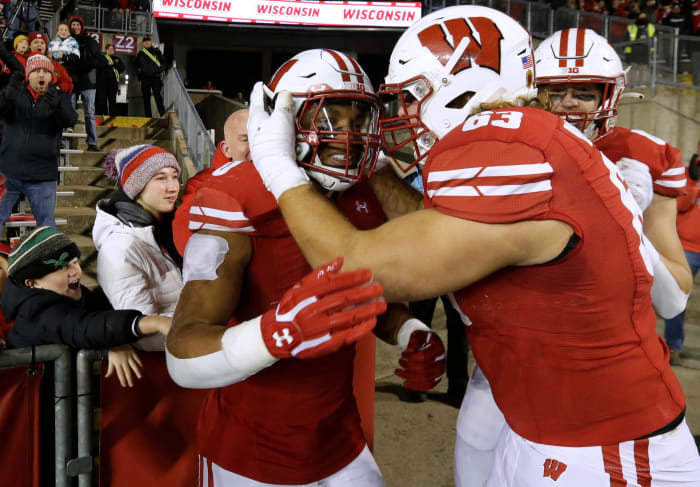 Wisconsin guard Tanor Bortolini celebrating with running back Braelon Allen after a touchdown run (Credit: MARK HOFFMAN/MILWAUKEE JOURNAL SENTINEL / USA TODAY NETWORK)